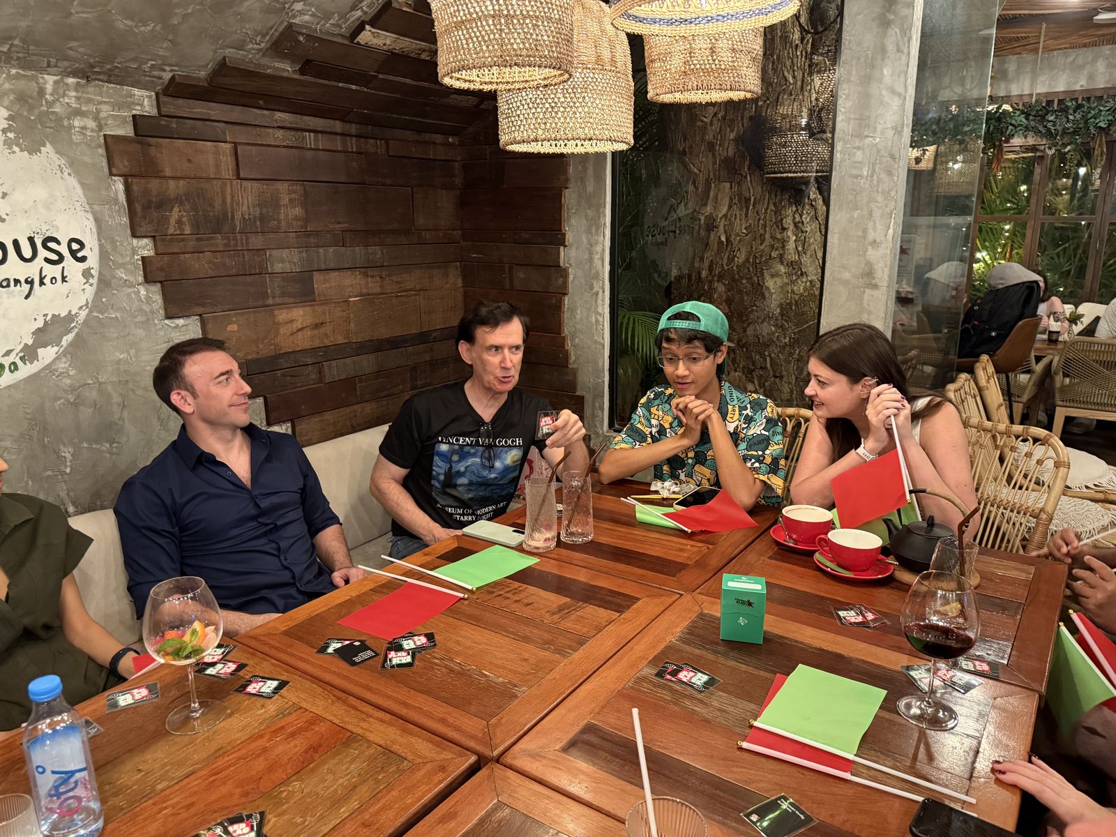 Guests chatting around a table at a Crimson Cat Game Night, Treehouse Cafe & Bar