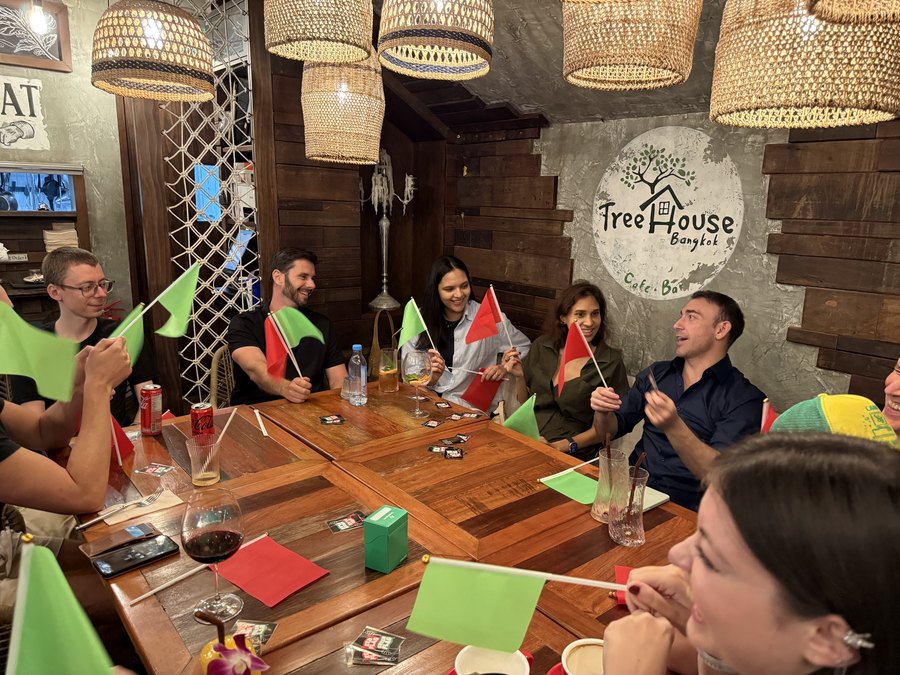 Guests around a table at a Crimson Cat Game Night, Treehouse Cafe & Bar, Bangkok